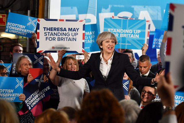 Britain’s Prime Minister Theresa May speaks during a general election campaign visit to a removal depot in Edinburgh, Scotland, Monday (Reuters photo)