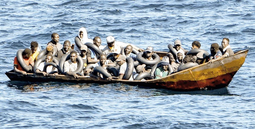 Migrants of African origin trying to flee to Europe are crammed on board a small boat, as Tunisian coast guards prepare to transfer them onto their vessel at sea between Tunisia and Italy, on Thursday (AFP photo)