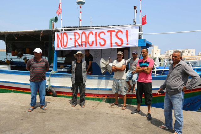Tunisian fishermen gather on Sunday in the port of Zarzis in southeastern Tunisia to protest against a possible berthing of the C-Star vessel, hired by far-right activists from a group which calls itself ‘Generation Identity’ to prevent would-be migrants from reaching Europe (AFP photo)