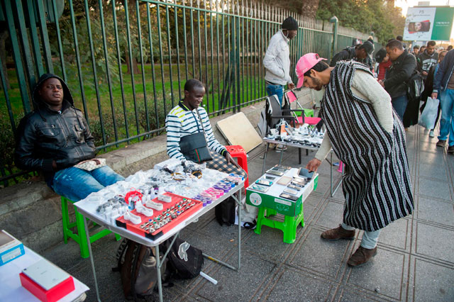 Migrant vendors sell cellphones on a sidewalk in the Moroccan capital Rabat on December 19 (AFP photo)