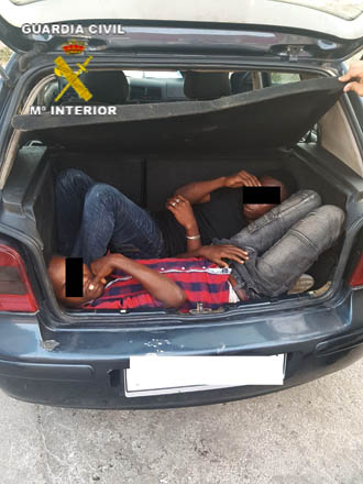 This handout picture taken on Saturday and released by Guardia Civil shows two African migrants hidden in the boot of a car that forced a frontier post between Morocco and the Spanish enclave of Melilla (AFP photo)