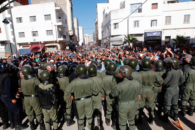 Demonstrators shout slogans in front of Moroccan security forces during a march in defiance of a government ban in the northern Moroccan city of Al Hoceima on Thursday (AFP  photo)