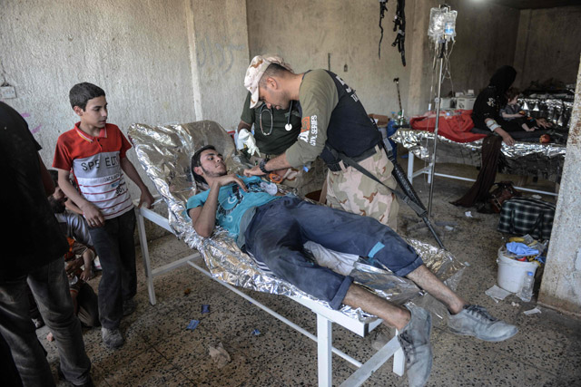 An Iraqi man, who suffered injuries following a suicide attack as he was escaping the Old City of Mosul, receives treatment at a field hospital on Friday (AFP photo)