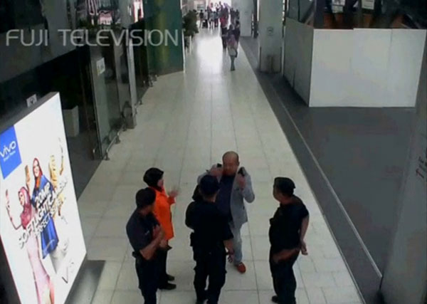 A still image from a CCTV footage appears to show a man purported to be Kim Jong-nam talking to security personnel, after being accosted by a woman in a white shirt, at Kuala Lumpur International Airport in Malaysia on February 13 (Reuters photo)