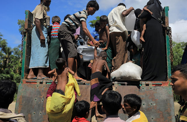 Rohingya refugees who arrived from Myanmar get onto a truck that will take them to a refugee camp from a relief centre in Teknaf, near Cox's Bazar in Bangladesh, on Friday (Reuters photo)