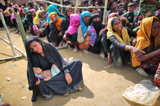 Rohingya people, fled from oppression within ongoing military operations in Myanmar’s Rakhine state, wait for food aid at a makeshift camp in Teknaff, Bangladesh, on Tuesday (Anadolu Agency photo)