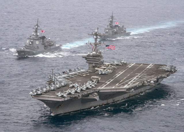 This US navy handout photo shows the aircraft carrier USS Carl Vinson, foreground, as it transits the Philippine Sea with the Japan Maritime Self-Defence Force Atago-class guided-missile destroyer JS Ashigara (DDG 178), and the JMSDF Murasame-class destroyer JS Samidare (DD 106), on Wednesday (AFP photo)