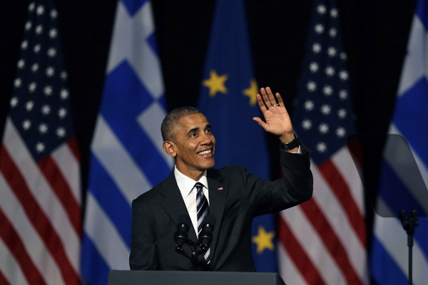 US President Barack Obama waves to the crowd as he delivers a speech at the new opera of Athens on Wednesday (AP photo)