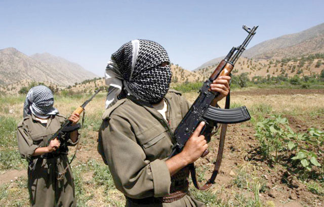 Kurdistan Workers' rebels patrolling an area in the Iraqi part of Qandil Mountains near their headquarters on the Iraqi-Iranian-Turkish borders in 2012 (AFP photo)