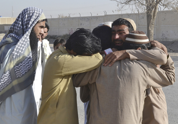 Pakistani family members of victims mourn outside a police training centre where gunmen opened fire in Quetta, Pakistan, on Tuesday (AP photo)
