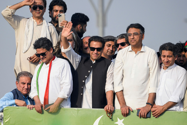 Ousted Pakistan's prime minister Imran Khan (centre) waves at his party supporters during a rally in Islamabad on Thursday (AFP photo)
