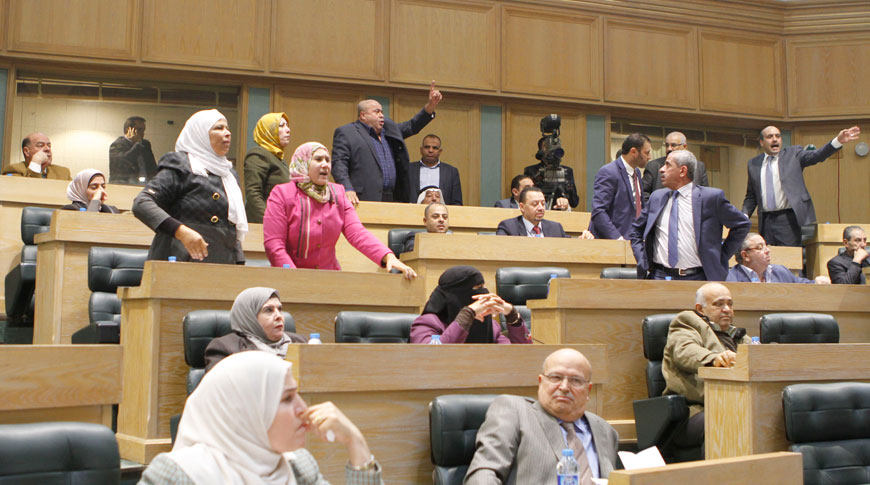 Deputies react during a heated debate over a deal reached between the government and MPs regarding recent price hikes on Sunday  (Photo by Osama Aqarbeh)
