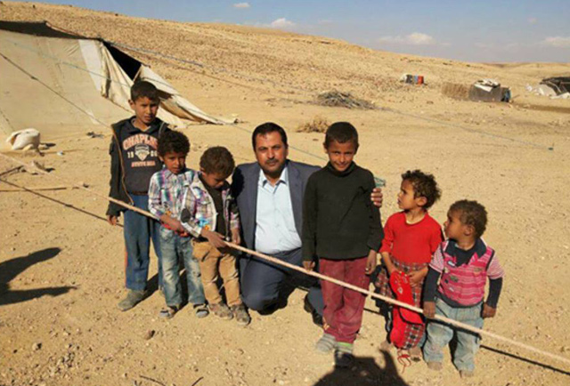 Firas Al Abbadi poses for a photo with children in a southern bedouin community (Photo courtesy of Firas Al Abbadi)