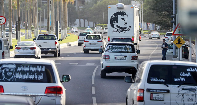 This file photo taken on June 11, 2017, shows portraits of Qatar’s Emir Sheikh Tamim Bin Hamad Al Thani on the back of vehicles and text reading in Arabic: ‘Tamim the glorious’ in Doha after the diplomatic crisis surrounding Qatar and the other Gulf countries spilled from social media to more traditional forms of media — all the way back to billboards (AFP photo)