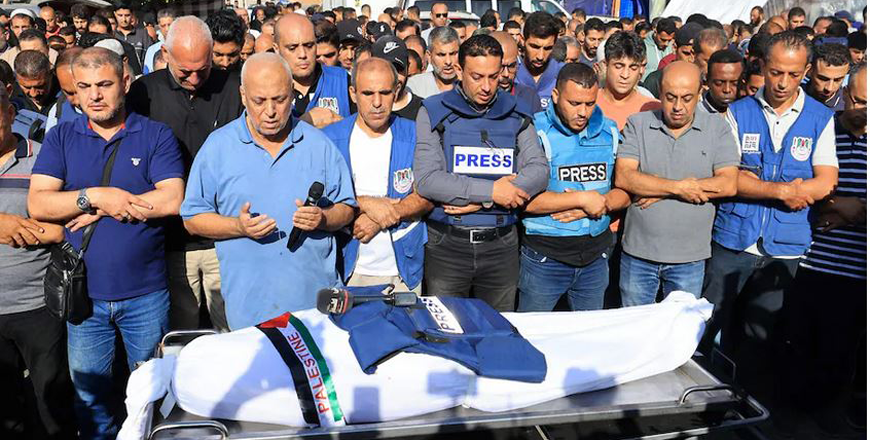 Journalists, relatives and friends pray over the body of Palestine TV journalist Mohammed Abu Hatab on Nov. 3 in Khan Younis, in the southern Gaza Strip  (Mahmoud Hams/AFP/Getty Images)