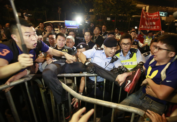 Protesters scuffle with police officers after clashing as thousands of people march in a Hong Kong street on Sunday (AP photo)