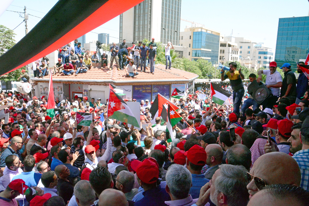 Activists rally near the professional associations’ offices on Wednesday in continuation of protests against the income tax draft bill (Photo by Amjad Ghsoun)
