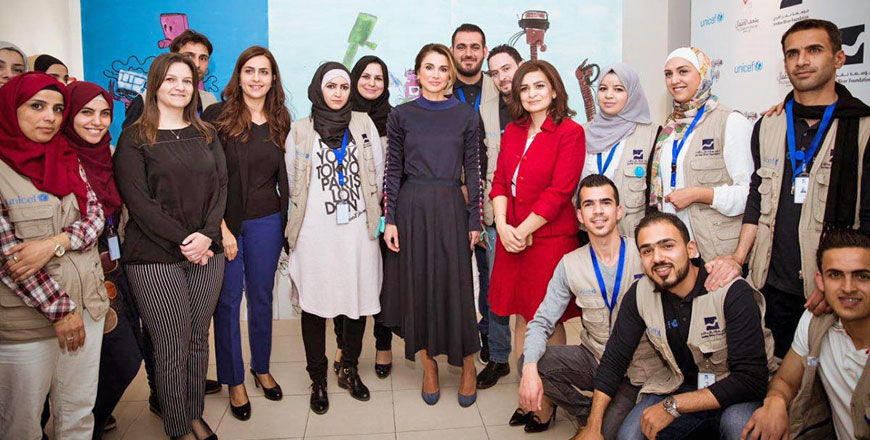 Her Majesty Queen Rania poses for a group photo at  the Mobile Emerging Technology Exhibitions at the Ras Al Ein on Tuesday (Photo courtesy of Royal Court)