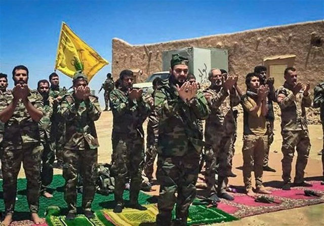 Akram Kaabi, the leader of Nujaba, leads prayers with Nujaba fighters in the town of Qayrawan, west of Mosul in this handout picture released by Tasnim News Agency, on May 27 (Reuters photo)