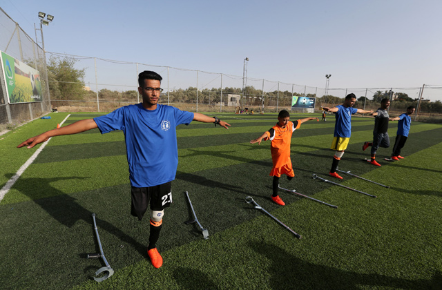 Members of a Palestinian amputee football team, which is made up of players most of whom lost their legs at the hands of Israeli occupation forces, exercise on a football pitch in the central Gaza Strip on June 21  (Reuters photo)