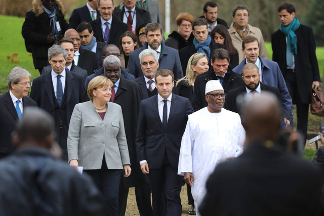 From left: German Chancellor Angela Merkel, France's President Emmanuel Macron and Mali's President Ibrahim Boubacar Keita arrive for a press conference during a conference to support the fight against terrorists in the African Sahel region at the Chateau of the La Celle Saint-Cloud, west of Paris, on Wednesday (AFP photo)
