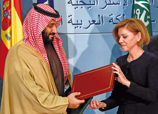 In this file photo, Saudi Arabia's Crown Prince Mohammed Bin Salman exchanges documents with Spain's Defence Minister Maria Dolores de Cospedal after signing a framework deal at the Moncloa Palace in Madrid, Spain, on April 12 (Reuters photo)