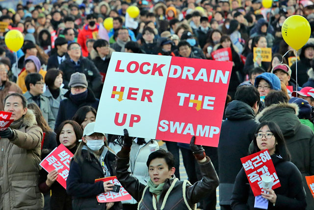 Protesters march towards the presidential house during a rally against impeached President Park Geun-hye in Seoul on Saturday (AP photo)