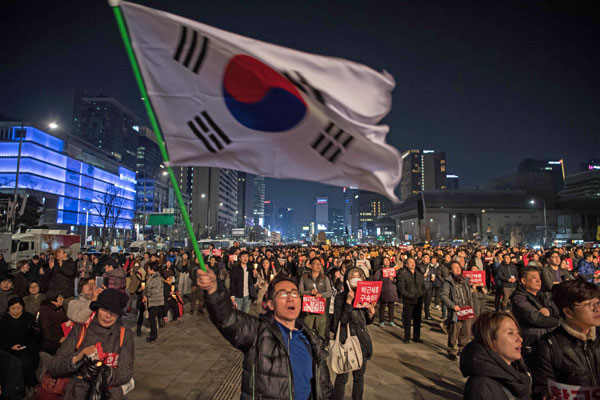 Anti-government protesters take part in a march in Seoul on Saturday. Tens of thousands of South Korean protesters held rival mass rallies over the impeachment of President Park Geun-hye as judges prepare to rule on the scandal that has rocked the country (AFP photo)