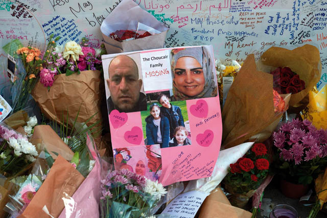 Images of members of the Choucair family, missing since the June 14 fire at the Grenfell Tower block, are pictured with floral tributes left near the Grenfell Tower block in Kensington, west London, on Saturday, following the Wednesday fire at the residential building (AFP photo)