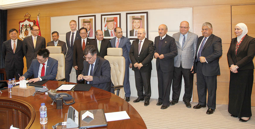 Prime Minister Hani Mulki (sixth left standing) acts as patron at a ceremony to sign the financial closure of an oil shale-fired power plant in Amman on Thursday  (Petra Photo)