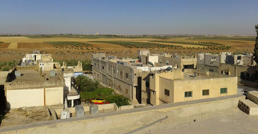 Houses and wheat fields are seen in the village of Emrawah in this June 11 photo (Photo courtesy of Emrawah News Facebook page)
