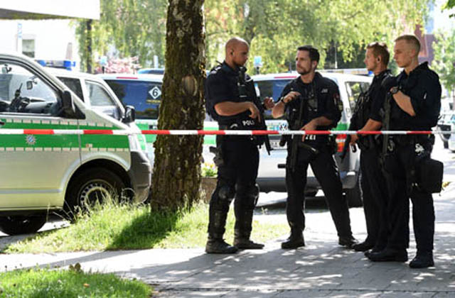 Police officers secure the area around a commuter rail station in Unterfoehring near Munich, southern Germany, where shots were fired, on Tuesday (AFP photo)
