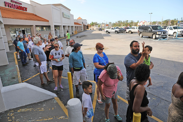 People wait in line outside of a hardware store two days after Hurricane Irma swept through the area on Tuesday in Fort Myers Florida (AFP photo)