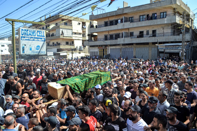 Mourners march with the body of one of the victims who drowned in the shipwreck of a migrant boat that sank off the Syrian coast, during his funeral after the return of his body in Lebanon's northern port city of Tripoli on Saturday (AFP photo)