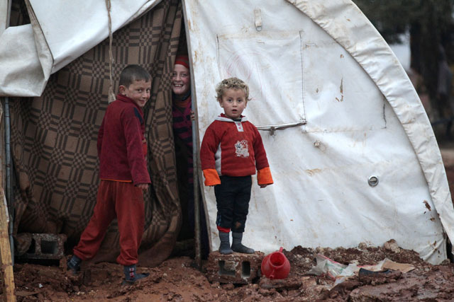 Internally displaced Syrian children stand at their tent in the Bab Al Salam refugee camp, near the Syrian-Turkish border, northern Aleppo province, Syria, on Monday (Reuters photo)