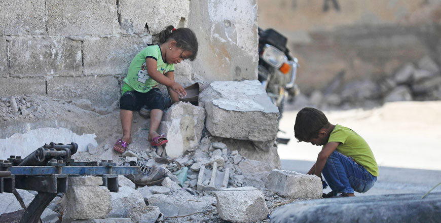 Syrian children play in Morek in the northern countryside of Hama province on Tuesday. The UN says it will open at least two human rights cases against Syria by year-end (AFP photo)