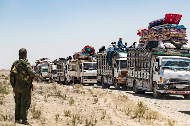 Syrian families sit in a truck after being released from the Kurdish-run Al Hol camp, which holds relatives of suspected Daesh terror group fighters, in the north-eastern Syrian Hasakeh governorate, on June 2 (AFP photo)