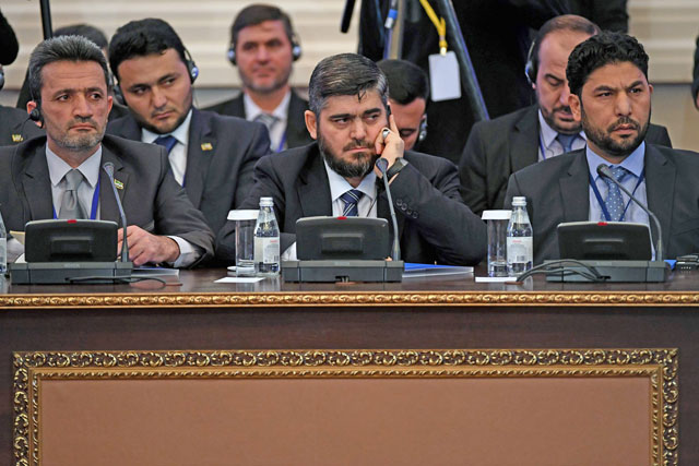 Chief opposition negotiator Mohammad Alloush (centre) of the Jaish Al Islam (Army of Islam) rebel group attends the first session of Syria peace talks at Astana’s Rixos President Hotel on Monday (AFP photo)