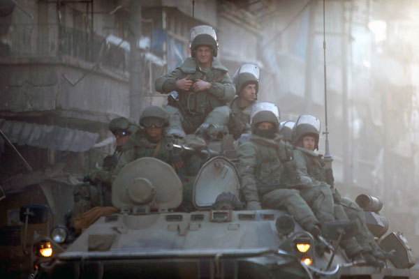 Russian soldiers, on armoured vehicles, patrol a street in Aleppo, Syria, February 2 (Reuters photo)