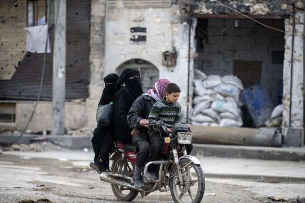 Syrians who have returned to their home after Al Bab town centre has been entirely freed from Daesh extremists as part of operation ‘Euphrates Shield’, ride on a motorcycle in Aleppo, on Sunday (Anadolu Agency photo)