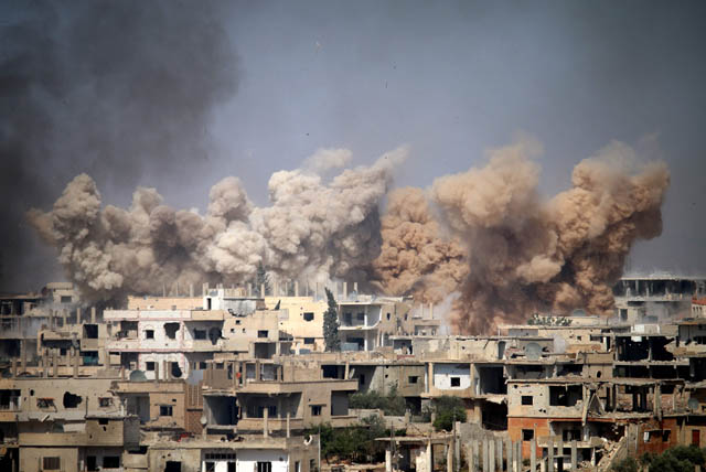 Smoke rises from buildings following a reported air strike on a rebel-held area in the southern Syrian city of Daraa on Wednesday (AFP photo)