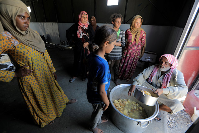An internally displaced girl who fled Raqqa city waits to receive food at a camp in Ain Issa, north of Raqqa, Syria, on Monday (Reuters photo)