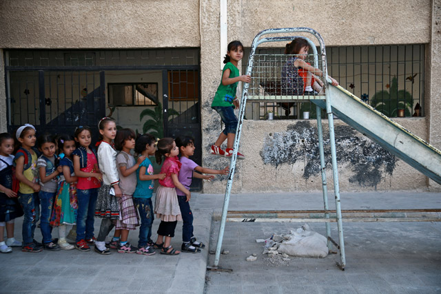 Students play in a playground at a school in Douma, near Damascus, Syria, on Wednesday (Reuters photo)