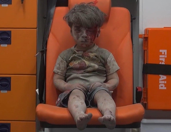 In this frame grab taken from video provided by the Syrian anti-government activist group Aleppo Media (Centre), 5-year-old Omran Daqneesh sits in an ambulance after being pulled out of a building hit by an air stirke in Aleppo, Syria, on Wednesday (AP photo)