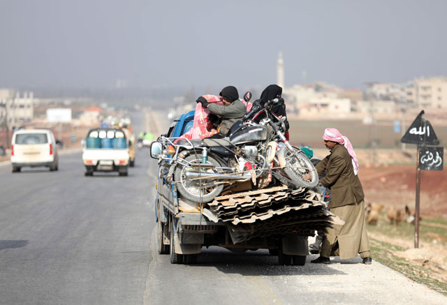 A displaced family from a village in southern Idlib head on the Damascus-Aleppo motorway towards the northern part of the rebel-held province on Saturday (AFP photo)