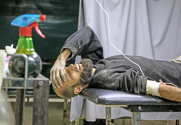 A wounded man lies on a stretcher in a hospital after Assad regime allegedly carried out an assault to besieged Eastern Ghouta of Damascus, Syria, on Thursday (Anadolu Agency photo)