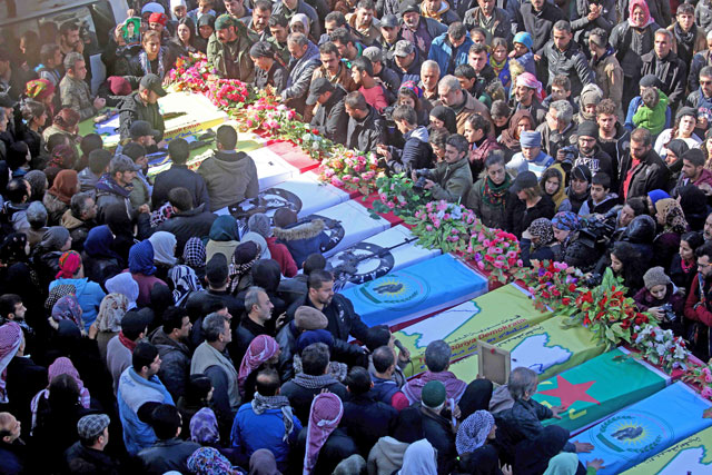 Syrian Kurds mourn during a funeral of civilians and fighters from the Syrian Kurdish People’s Protection Units who were killed in battles in Syria’s border region of Afrin as the Turkish army presses an offensive against Kurdish militia in the area, in the town of Afrin, on Monday (AFP photo)