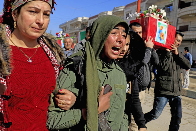 Syrian Kurds mourn during a funeral of civilians and fighters from the Syrian Kurdish People’s Protection Units who were killed in battles in Syria’s border region of Afrin on Monday (AFP photo)
