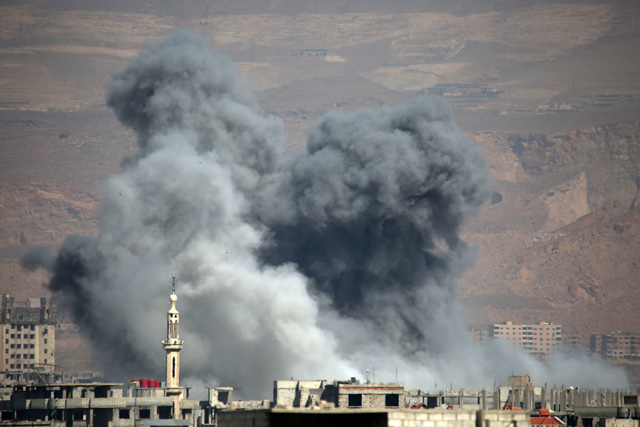 Smoke billows following Syrian government bombardment on the rebel-controlled town of Arbin, in the besieged Eastern Ghouta region on the outskirts of the capital Damascus, on Sunday (AFP photo)