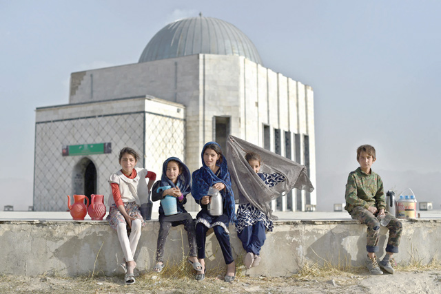 Afghan children selling tea and water wait for customers at Nadir Khan hilltop in Kabul on October 10 (AFP photo)